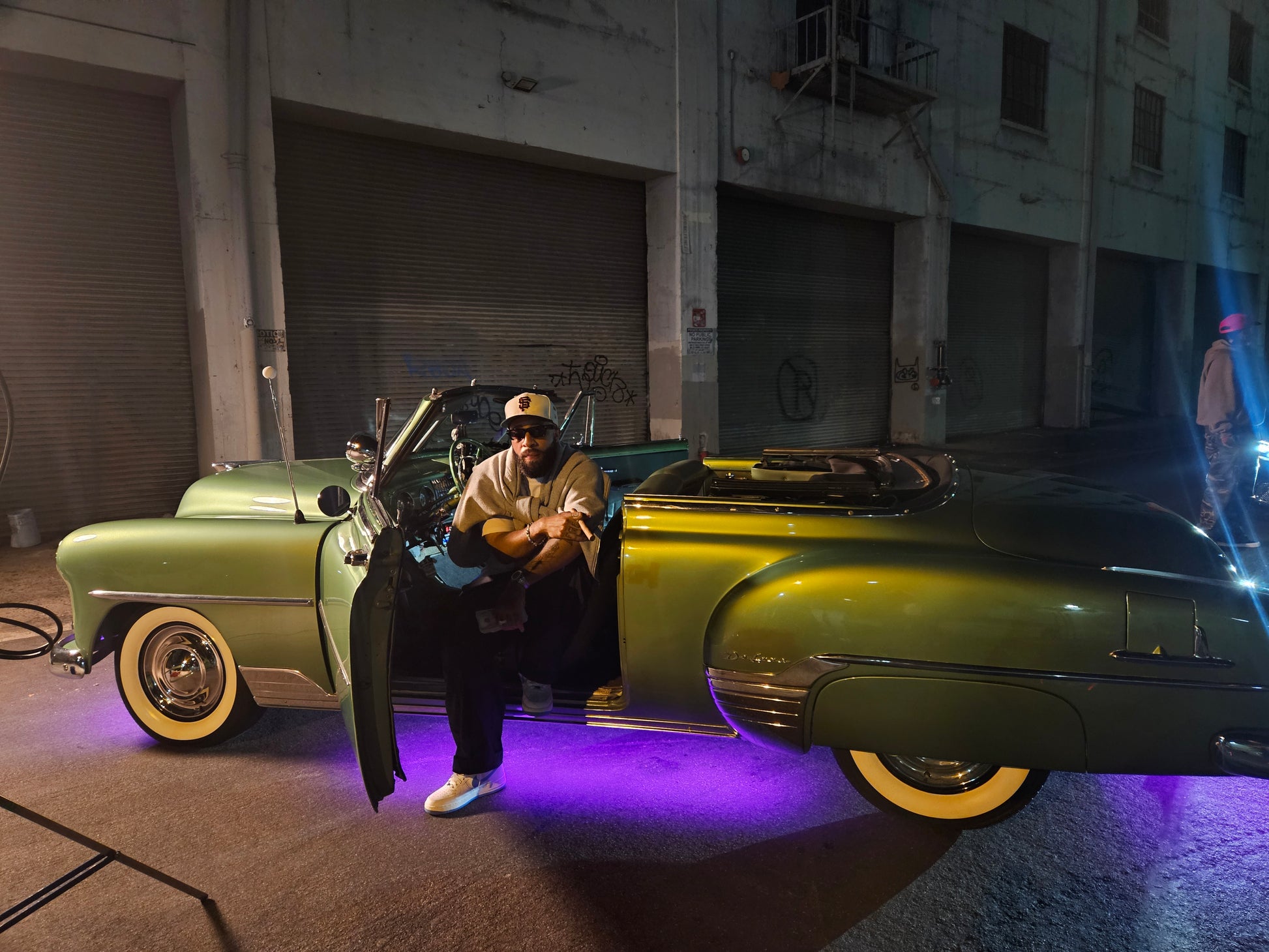 Music artist, Larry June sitting in our classic car on set filming his music video in downtown Los Angeles. 